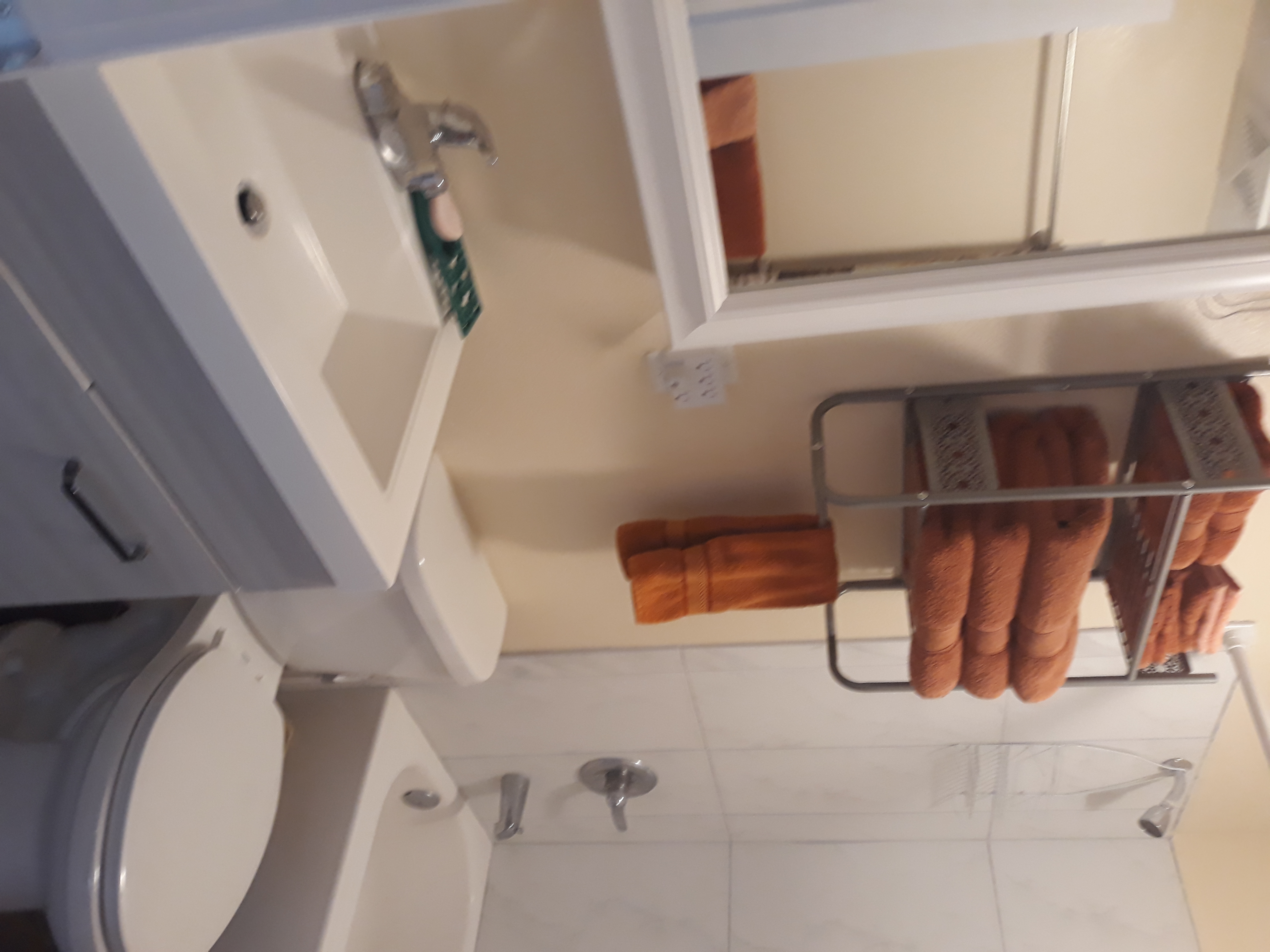 Bathroom has a medicine cabinet and built in lighted makeup mirror